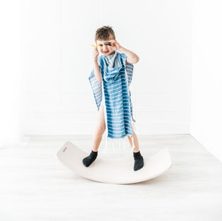  Little boy wearing a blue Kids Towel Poncho 