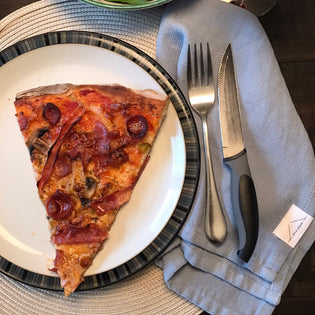  Homemade pizza on a plate with fork and knife and House of Jude Cloth Napkin